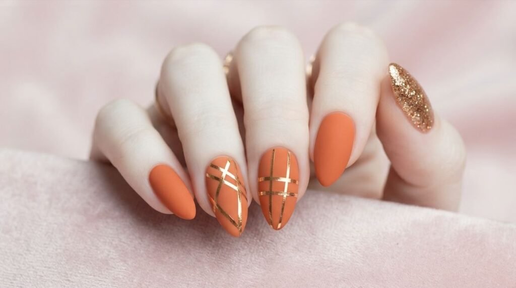 Applying copper chrome press-on almond nail onto 18-year-old female hand with pale skin.