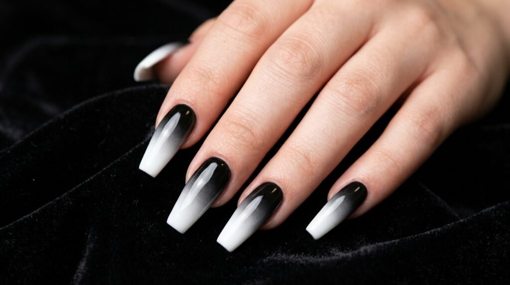 Macro shot of coffin nails showing a seamless transition from black to white polish.