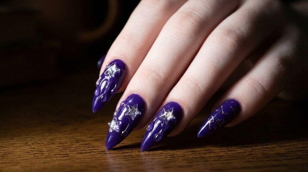 Long stiletto nails with 3D gel textures and star charms on an 18-year-old female hand with white skin.