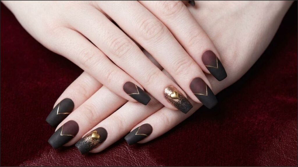 Atmospheric close-up of moody matte black and burgundy gradient nails on a white female hand (18), holding a dark crystal.