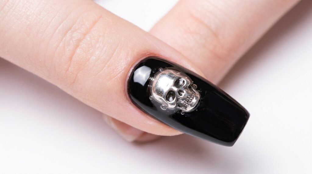 Macro view of silver 3D skull charm bonded securely with clear gel on black coffin nail.