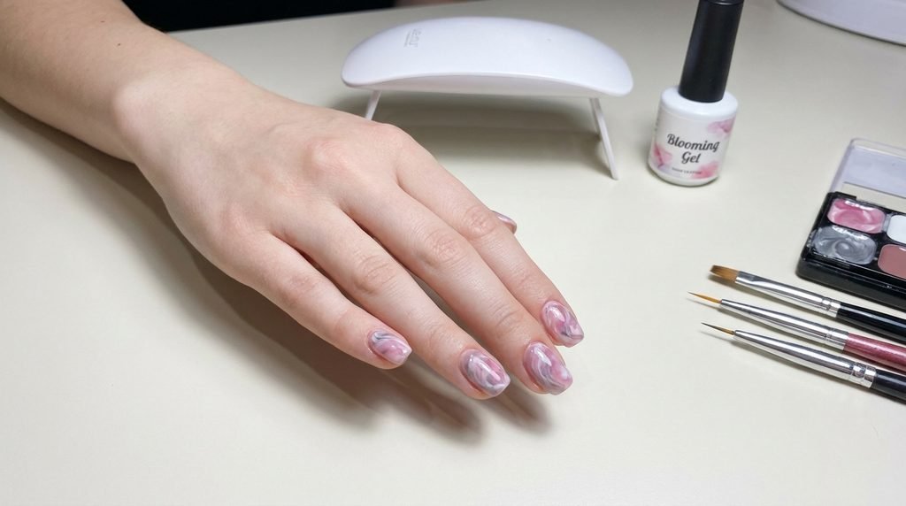 DIY gel nail kit tools laid out beside finished smoky black marble nails on an 18-year-old female hand.