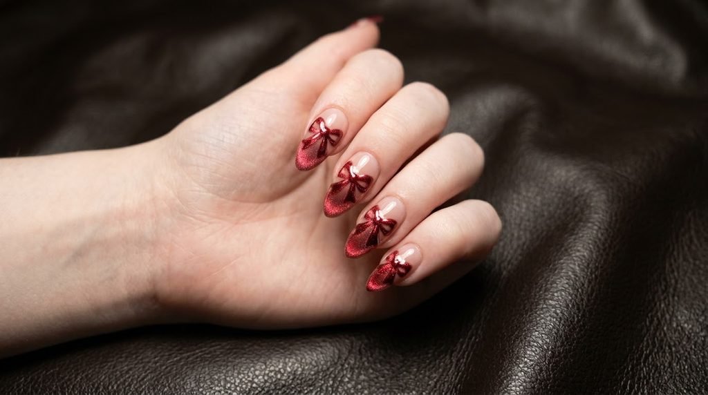 Velvet red ribbon cat eye nail design on almond nails.