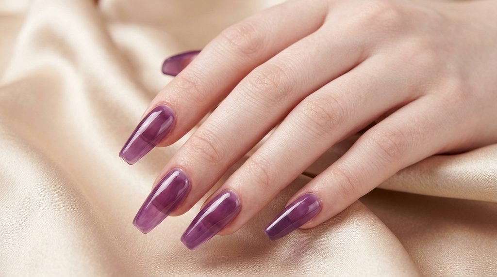 Translucent amethyst purple jelly nails on an 18-year-old female hand over champagne silk.