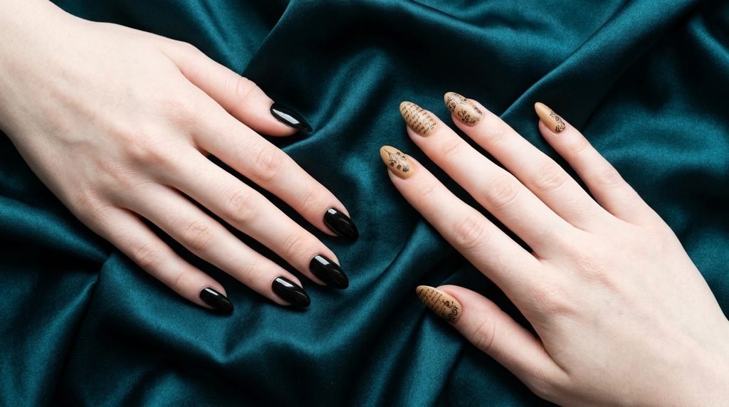 Two white-skinned hands contrasting black base nails against tan vintage parchment base nails.